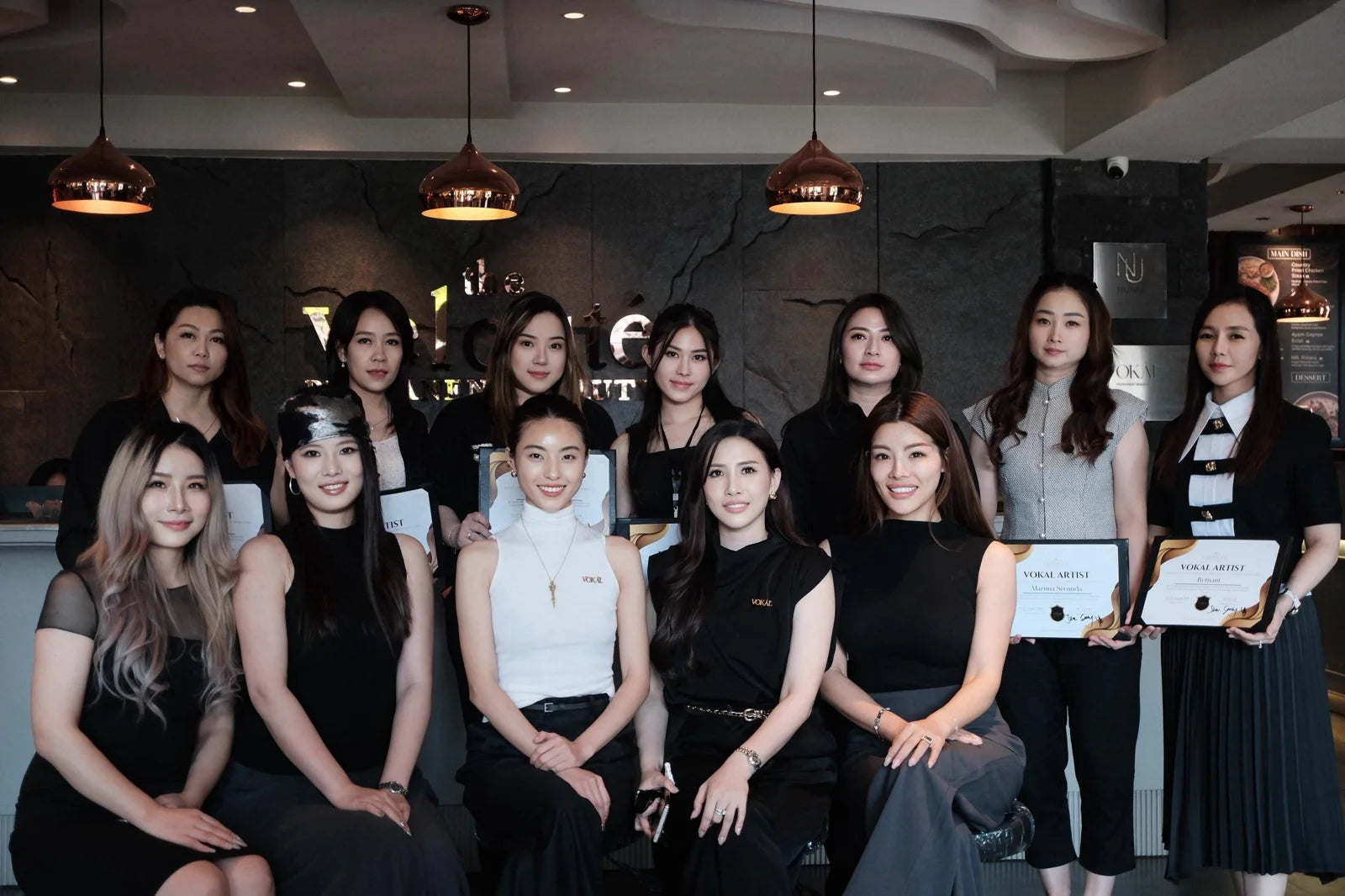 A VOKAL class group holding their course certificates